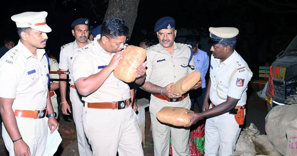 Police officers inspecting and seizing wrapped packages of contraband during an operation.