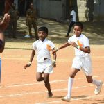 Young students participating in a running race during a school sports day event.